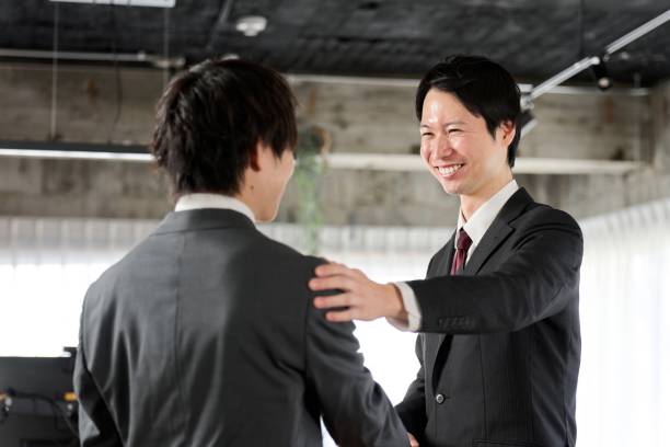 Asian businessman encouraging his subordinates