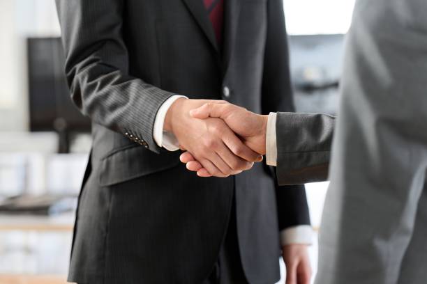 istock Asian business people shaking hands in the office 1974779747
