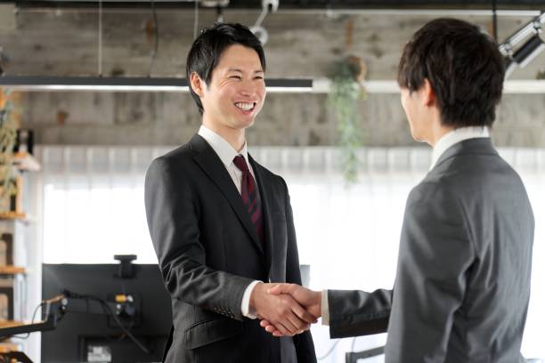 istock Asian business people shaking hands in the office 1974779748
