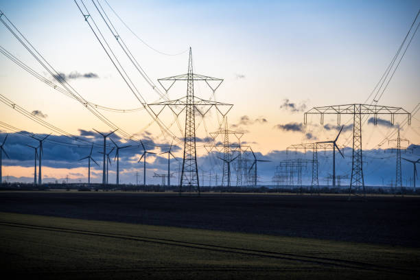 istock Wire electrical energy and wind turbines at sunset 1974780872