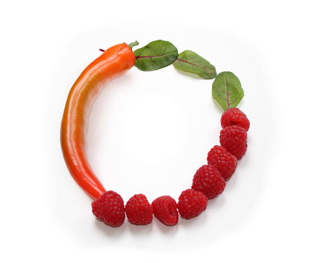 Letter O, number 0, circle frame made from orange chili pepper, green salad lettuce leaves and red raspberries ABC capital letter made of chillies, peppers, for texts, encyclopedias, cook book, cookery books, and artificial words related to vegan or a vegan January, letters isolated for decoration of menu cards, flyer, brochure, booklet, voucher, coupons, invitation card and gift present vouchers