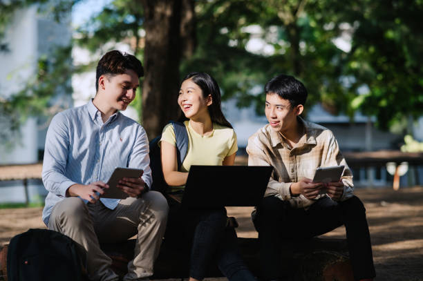 istock 3 Multiracial Group Of Students Talking In University Garden. 1974799232
