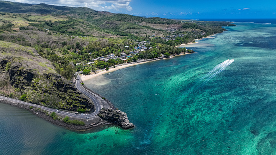 This photo captures an expansive view of the ocean and coastline in Mauritius from an aerial perspective, showcasing the natural beauty of the region.