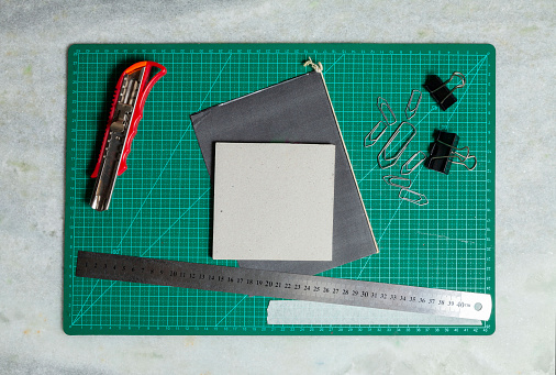 Green cutting table with craft accessories. Craft concept. DIY concept.