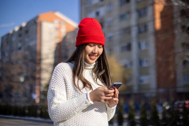 istock Young woman using smartphone in city during day 1974843914