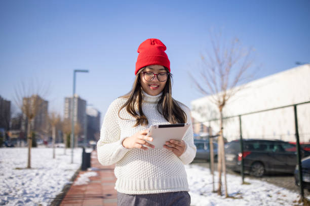 istock Young woman using digital tablet in city during day 1974845521