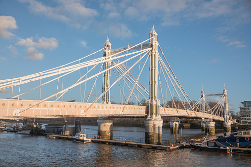 The Albert Bridge, an iconic 19th-century wrought-iron suspension bridge, elegantly spans the Thames at Chelsea, seamlessly linking the north bank with the south at Battersea. A timeless marvel of engineering and design, it stands as a testament to London's rich history and architectural heritage