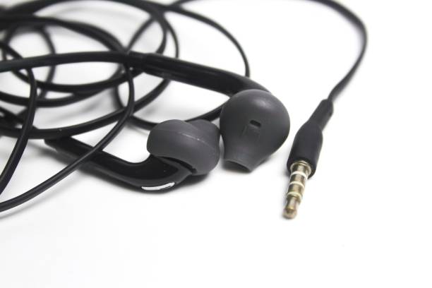 istock Black wired earphones on a white background 1974871319