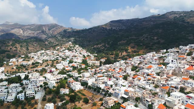 Drone footage of a town in Greece with white houses