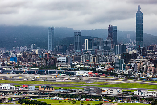 View of downtown Taipei with Taipei 101 skyscraper in the background and Songshan Airport in the foreground.