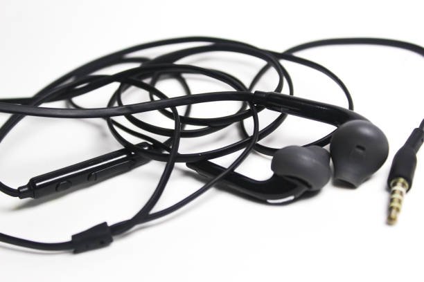 istock Black wired earphones on a white background 1974893055