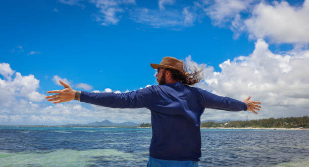istock Man Standing on Boat in the Ocean 1974897842