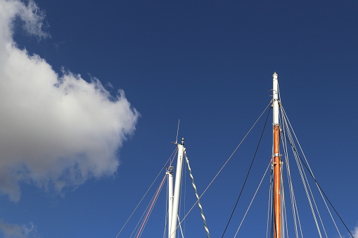 sailing boat masts and blue sky in the old port of Palermo