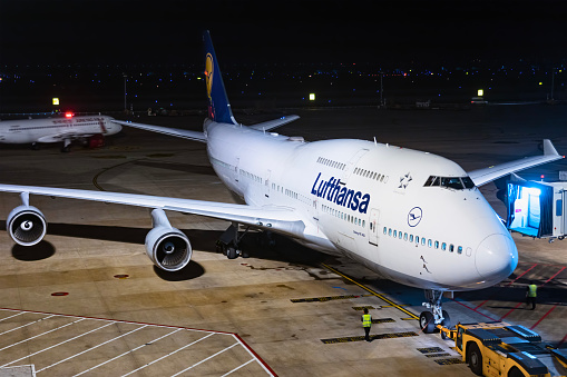 A Boeing 747 aircraft operated by german airline Lufthansa parked at night