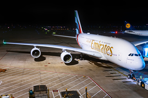An Airbus A380-800 aircraft operated by Emirates Airlines parked at night