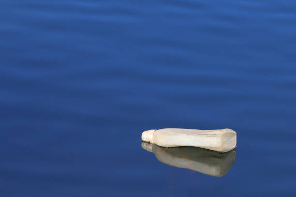 istock pollution, plastic bottle floats in a blue sea 1974916085