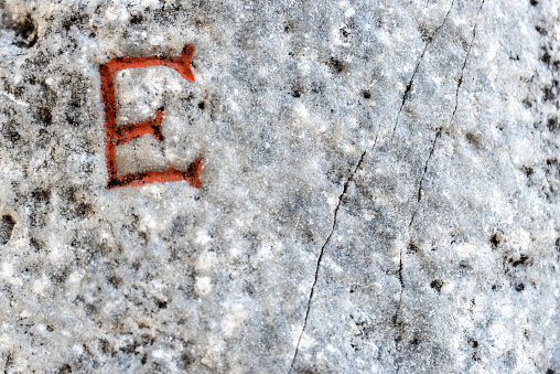 letter E written on old marble