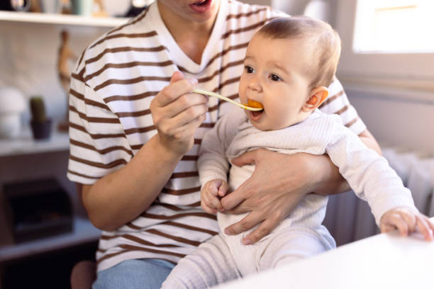 istock Unrecognizable female person feeding baby 1974923682