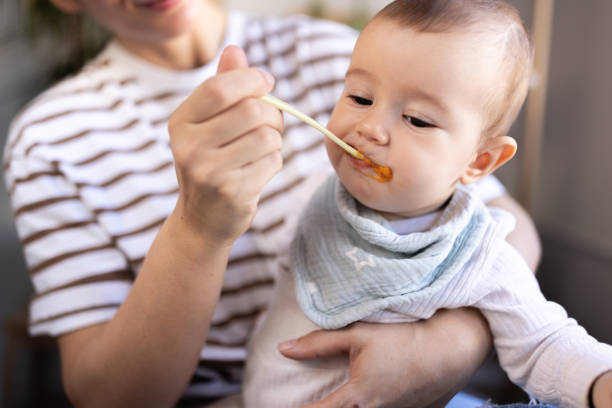 istock Unrecognizable mother feeding her baby 1974925269