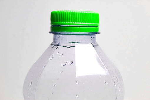 close up of plastic bottle with green cap