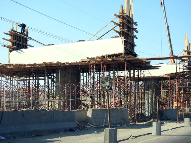 Giza, Egypt, January 7 2024: A construction site of a new bridge that is under construction with a mobile crane and workers, Egypt new real estate projects and infrastructure