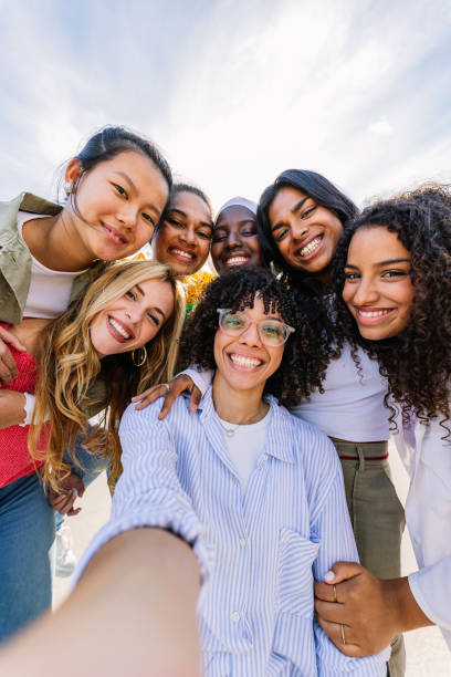 Diverse group of happy young best female friends having fun together outdoors. Diverse group of happy young best female friends having fun together outdoors. International youth community concept with multiracial girls from different cultures smiling at camera. black african girls pictures stock pictures, royalty-free photos & images