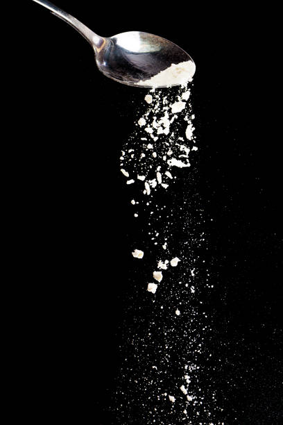 istock Flour fall down in air. Black background Isolated, selective focus 1974992920