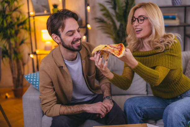 istock Two friends sharing a pizza at home 1974997140
