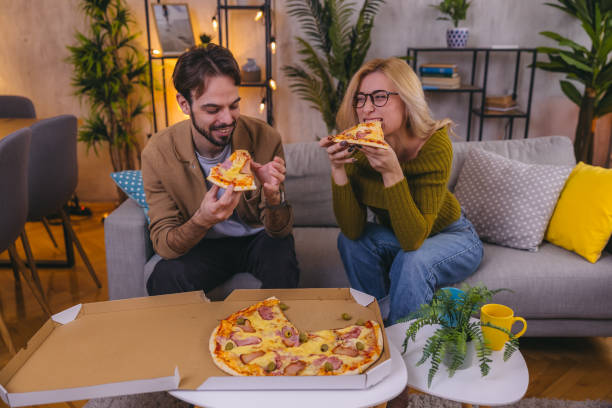 istock Two friends sharing a pizza at home 1974997652