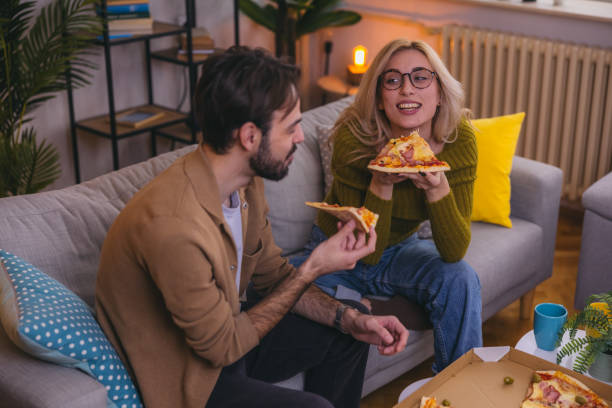istock Two friends sharing a pizza at home 1974997686