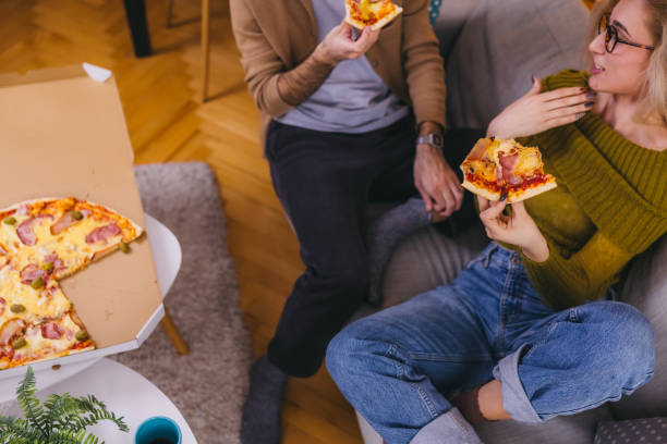 istock Young couple sharing a pizza at home 1974998201