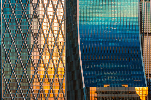 Low angle of modern highrise building with reflection glass in the city wth blue sky