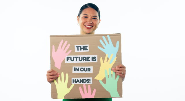 Woman, smile and holding a poster, future and mockup in studio, hands and portrait by white background. Asian person, youth and hope in community, happy and trust in solidarity, support or donate