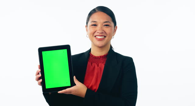 Business woman, tablet green screen and mockup for human resources website or job advertising in studio. Professional face of asian worker in HR, digital mockup or tracking marker on white background
