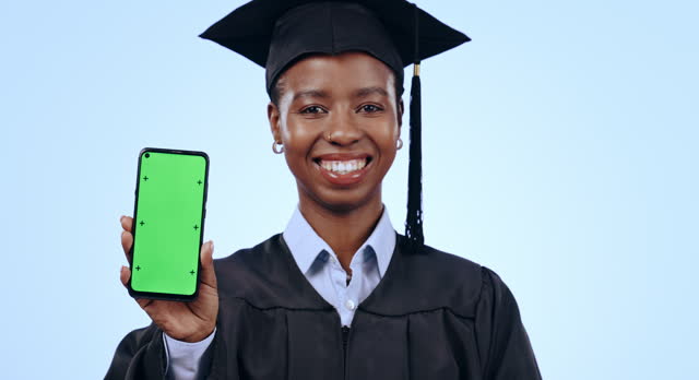 Graduate, woman and phone green screen for university marketing, contact or information on blue background. Face, graduation and african student with mobile mockup, e learning and education in studio