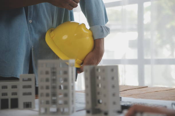 istock Construction and structure concept of Engineer or architect meeting for project working with partner and engineering tools on model building and blueprint in working site, contract for both companies. 1975062014