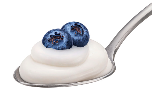 Spoon of yogurt and blueberry isolated on white background, full depth of field