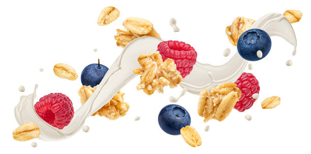 istock Falling granola with milk splash and berries isolated on white background 1975071664