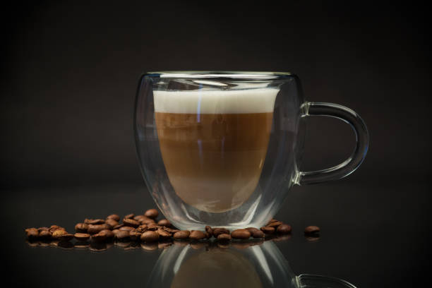 istock hot coffee with milk on black background 1975076083