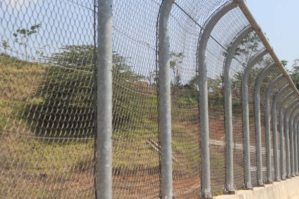 istock wire fence dividing the road 1975085133