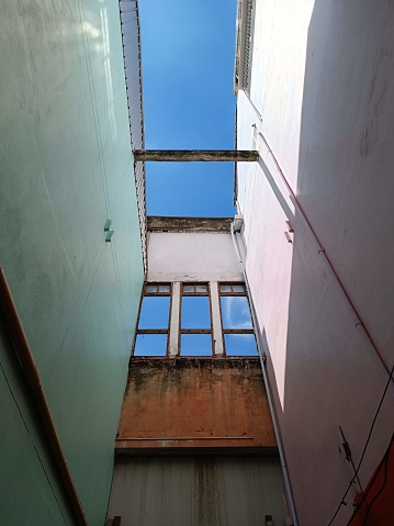 a view of the sky from between two buildings.