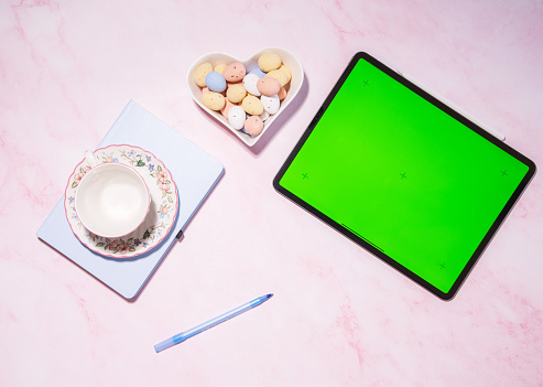 woman holding soft cheese and strawberry sandwich near green screen tablet, concept of healthy food and diet, using calorie counting app, top view, High quality photo