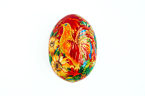 Ukrainian Easter egg with Petrykivka painting. Isolated on a white background. Hand painted wooden decor. Small gift for mom.