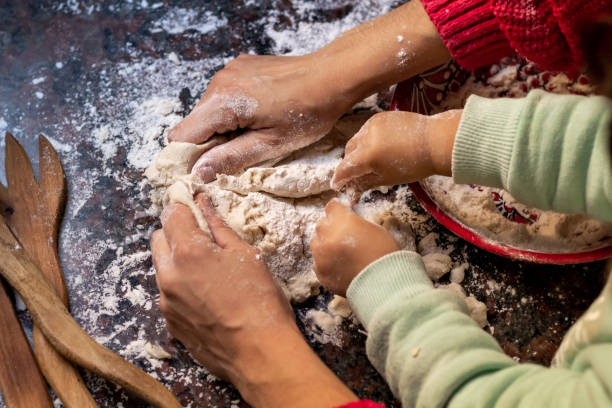 istock there are two people making bread together on a table next to utensils 1975160445