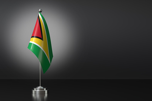 Small Co-operative Republic of Guyana Flag in Front of Black Background, 3d Rendering