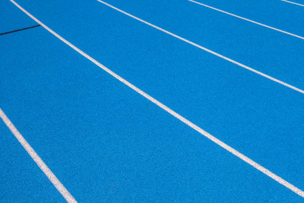 istock Blue Olympic track lanes with white stripes, an empty background suitable for copy space, represent the concept of physical sports and running, symbolizing commitment and pathways towards goals 1975192533