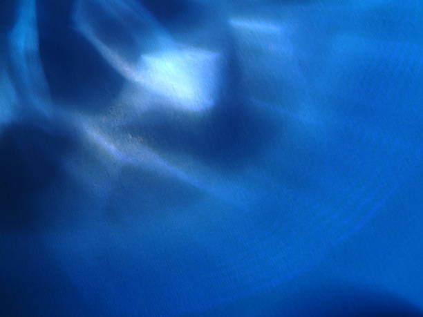 istock Blue abstract art background silk texture and wave lines in motion for classic luxury design 1975223233