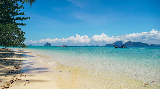 The beach of Koh Kradan Island Thailand, relaxing beach with a turquoise colored ocean. Beautiful summer beach with white sand, clear water and blue sky. Travel and holiday concept.