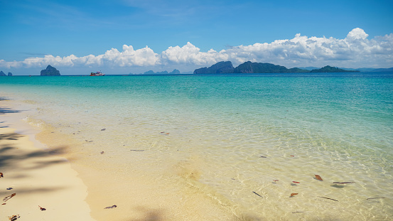 The beach of Koh Kradan Island Thailand, relaxing beach with a turquoise colored ocean. Beautiful summer beach with white sand, clear water and blue sky. Travel and holiday concept.