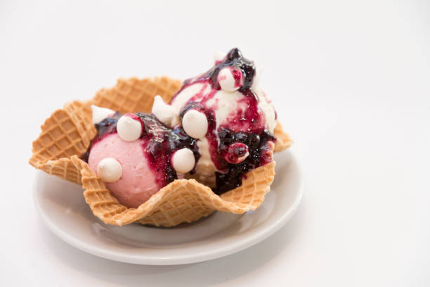 Strawberry ice cream dessert with meringues close-up on white background